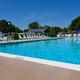 On-site swimming pool photo showing pool deck, lounge chairs and amenities — demonstrates guest recreation facilities.
