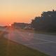Sun rising over Ocracoke campground capturing sunrays streaming over A loop campsites on exterior perimeter of campground