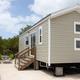 Vacation rental at Big Pine Key RV Park in Florida with a picnic table and chairs on the exterior.