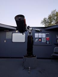 Interior observatory telescope shot showing mounted telescope and informational displays — documents the property’s observatory amenity (1000008015).