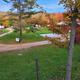 Elevated/near-overhead perspective of the campground showing road loop, multiple sites and surrounding trees — useful overview of the property layout. (Image appears on the campground homepage.)