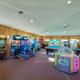 Indoor arcade/game room with multiple machines and pool table — documents additional on-site amenities available to guests (part of the property’s facilities images).