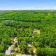 High-altitude aerial view showing the campground footprint within surrounding forest — good overall property overview. Matches site hero/gallery context on the homepage.