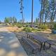 Picnic area foreground with park benches and RVs visible in the background — highlights onsite picnic/facility area and nearby campsites (from the property page).
