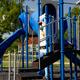 Playground equipment set on park grounds — shows family-friendly onsite recreation (homepage background/slide).