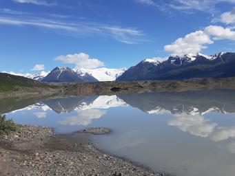 Another lakeshore/glacier view showing shoreline and reflections; supports scenic character of the property (page context notes ‘PERFECT Conditions!’).