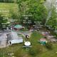Aerial annotated overview of the entire Rock Tavern River Kamp property showing yurts, tents, parking, river and access — good overview for a gallery and matches page context/map.