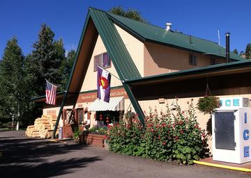 Photo of the campground office/building (entrance, signage, ice machine visible) from the About Us page — useful to show on-site services and facilities.
