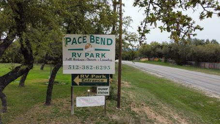 Clear photo of the Pace Bend RV Park roadside sign at the property entrance — confirms location and entry signage (used on the homepage).