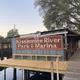 A dock with a sign that says kissimmee river park & marina