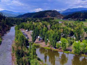 Another aerial/overview thumbnail showing the river bend, RVs and site layout (from the Amenities page) — provides a broader view of property setting and river adjacency.