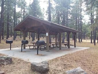 Day use picnic area with grills, tables, and a shade structure