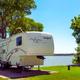 Travel trailer parked near the lake at Lost River RV Park