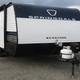 Clear image of a trailer on the dealership lot providing a close-up view of inventory and lot surface, useful to show the types of RVs sold and the outdoor display space.