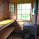 Gut Island Cabin 2 interior showing stove and wooden shelves