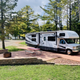 Concrete patio full-hookup RV site with picnic table and fire ring — useful for showing premium RV pitch layout and onsite hardscape as seen on the park’s sites descriptions.