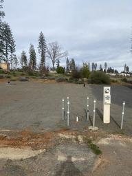 Empty prepared RV lot with utility hookups visible — useful to show available RV pad infrastructure advertised on the site (RV lot listing).
