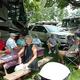 Group of people seated at a picnic table beside RVs — shows campground/RV social area and typical RV setup at the resort (image appears in the site’s camping/gallery content).