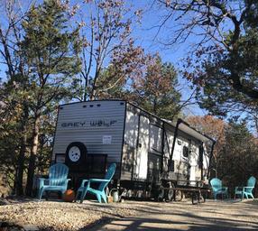 Level gravel RV site with full hook-ups at Branson Shenanigans RV Park