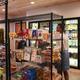 Interior photo of the on-site provisions/shop area with stocked shelves and refrigerators — documents guest services available at the property.