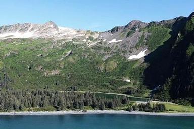 Glacier-carved peaks at Kenai Fjords National Park with the bay in the foreground