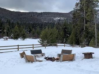 Benches around a campfire in the wintertime.