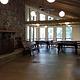 Inside of the Clark Lake pavilion showing picnic tables, benches, and fireplace.