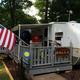 Campsite scene with a travel trailer, attached deck and campsite furnishings — useful close-up of typical campsite setup from the RV camping page.