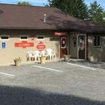 Exterior of a facility building (office/restrooms) with parking — documents on-site amenities and services; located on the Campground Amenities page.