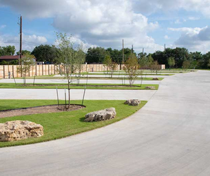 Shows multiple concrete RV pads, landscaped islands and open lanes — a view of the site’s lot design; image appears on the property site as an amenities/background image.