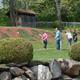 Image of guests playing putt‑putt on a landscaped green with rock wall and grounds signage — highlights onsite recreational facilities (mini-golf) and landscaped grounds on the property gallery.