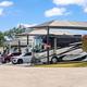 Motorcoaches parked at paved RV sites at Lantern Oaks RV Resort