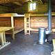 Shakes Slough 1 Cabin interior showing wood beds  and table