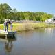 Fishing dock and waterfront view showing cabins and RVs across the lake — appears on the property’s community page and highlights lake access and on-site cabins.