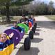 Colorful barrel-train ride with guests on a campground road — depicts an on-site recreational activity described on the property page.