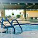 Hot tub/ spa area with steps, seating and covered pavilion visible — highlights the resort's spa amenity and poolside facilities (from the property's About page).