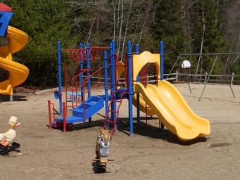 Playground equipment on sandy surface — documents on-site play area for children (gallery page).