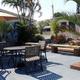 Patio seating and landscaped courtyard area with umbrellas and plants — shows another common amenity/relaxation space on the resort grounds.