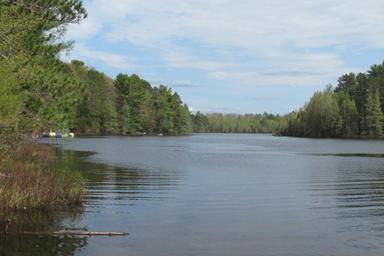 Wide lake view showing shoreline and water — represents the campground’s waterfront (photo gallery lake shot).