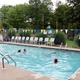 Clear daytime photo of the campground pool with deck chairs and fencing — shows an on-site amenity. Sourced from the site’s Amenities page (amenities.html), supporting that this is the property pool.