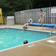 Swimming pool with patrons and pool deck visible — documents an on-site amenity and recreation facility.