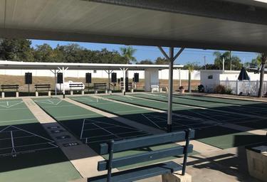 Covered shuffleboard/pickleball courts and seating area — shows on-site recreation amenities that appear in the resort’s photos and amenities listing.