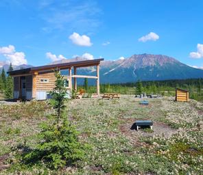Pavilion structure with picnic tables, cornhole and expansive mountain views — highlights communal facilities and site setting (from The Pavilion page).