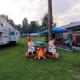 Wide dusk shot showing multiple RVs and sites with open grassy aisles — good overall view of the campground's RV camping area (used as a slider image on the site).