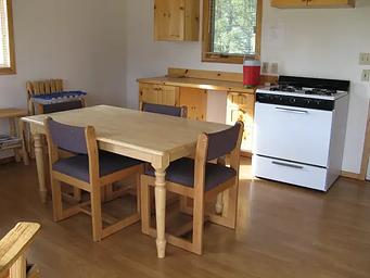 A small wooden kitchen table and counters in a cabin