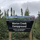Marion Creek Campground Portal Sign with trees and mountains in the background