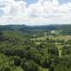 Aerial drone view of the property and surrounding mountains (homepage background image). Good overview showing site layout, river valley and context of the campground on the official site.