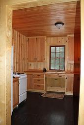 Kitchen of Peterson Cabin with Stove and refrigerator