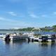 Clear waterfront view showing the resort’s dock and boats on Buffalo Lake — good overall site/lake perspective; appears on the property homepage header indicating it’s on-site.