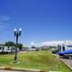 Wide view of RV parking and boat/RV storage with grassy center median and multiple units visible — shows site layout and available RV spaces (used on the rates/rv info page).
